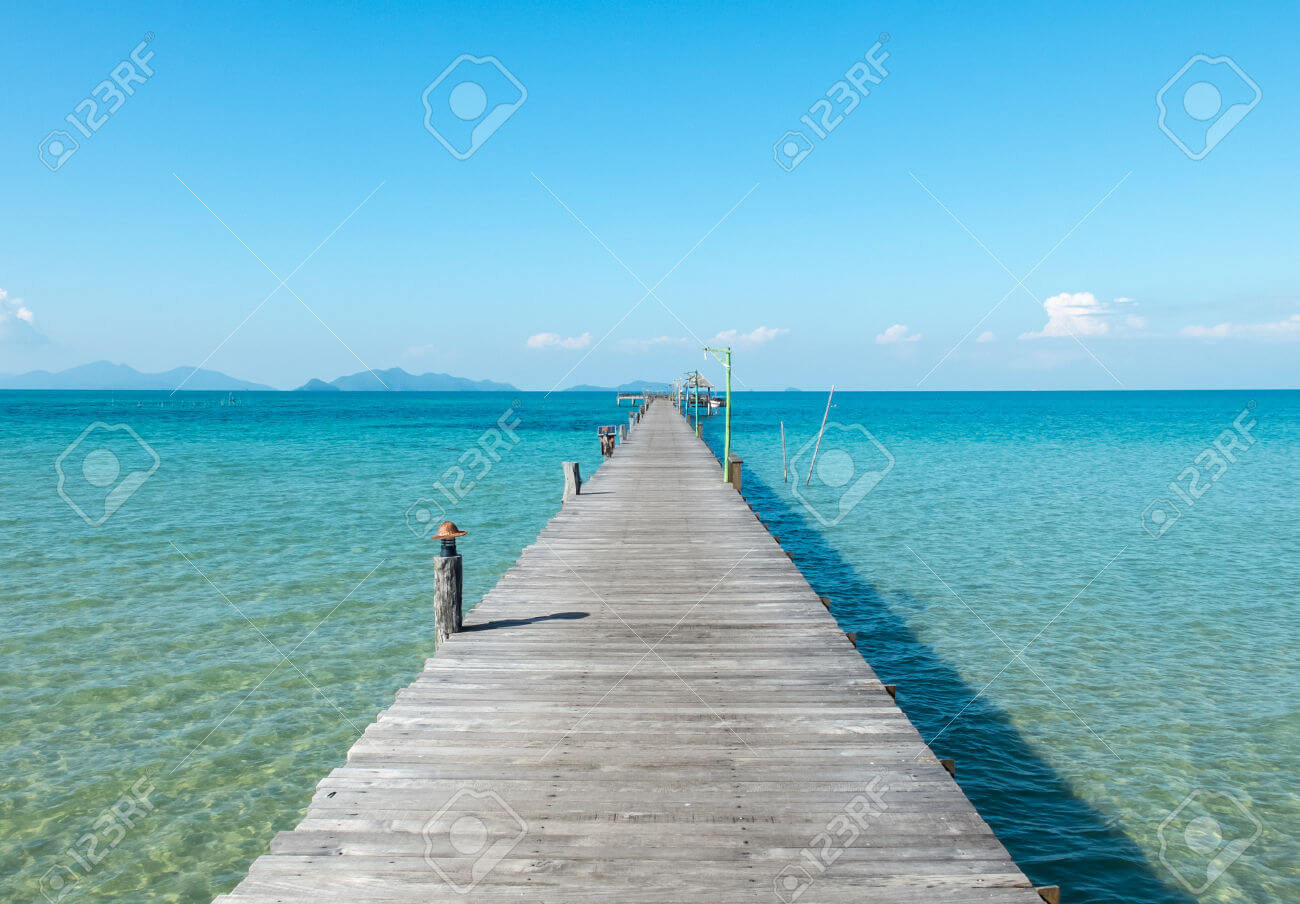 50822998 Vacation Time Concept Wooden Path Between Crystal Clear